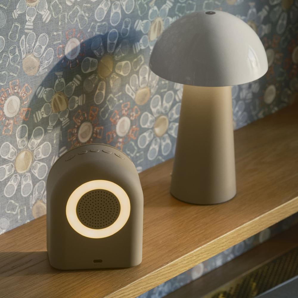 Ivory Bluetooth alarm clock speakers on a table, round mesh grilles and lit control