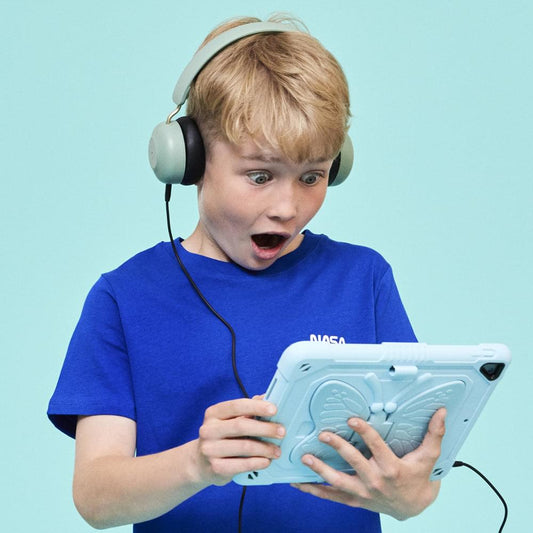Kids wireless headphones with dusty green ear cups, worn by a child