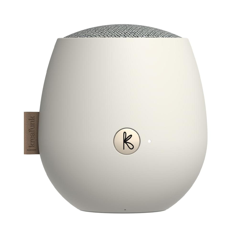 White Bluetooth speaker with fabric top and circular K logo on rear-facing side