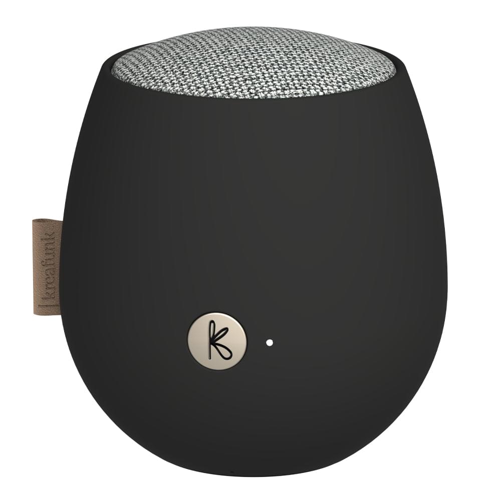 Black Bluetooth speaker close-up with fabric grille top and circular logo