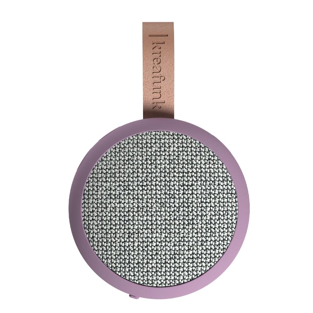 Round lilac Bluetooth speaker with gray fabric grille and brown leather hanging tag.