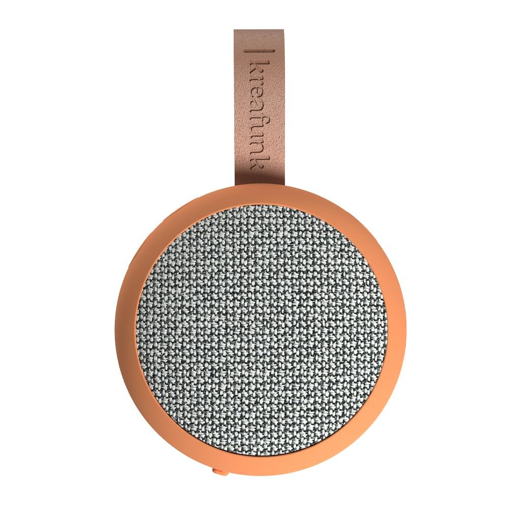Dusty orange Bluetooth speaker with gray fabric grille and fabric strap