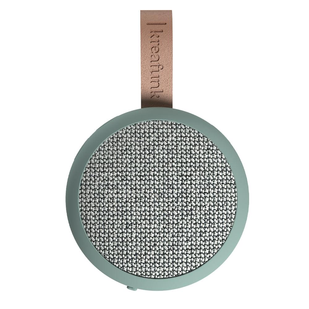 Dusty green fabric Bluetooth speaker front with textured grille and leather hanging tag
