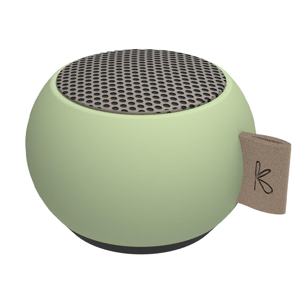 Dusty green mini Bluetooth speaker with top mesh grille and brown carry strap tag