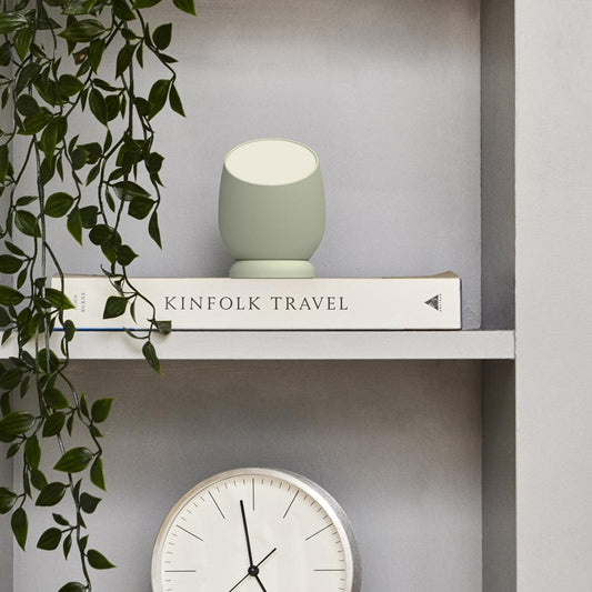 Kreafunk Beam lamp, dusty olive body with lit circular top