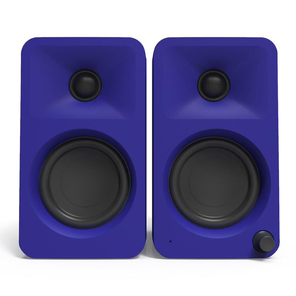 Matte purple desktop powered speaker pair showing dual front woofers and tweeters