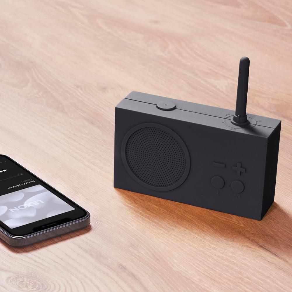 Grey portable radio and Bluetooth speaker with speaker grille and upright antenna