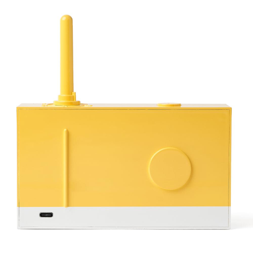 Yellow portable FM radio and Bluetooth speaker side panel with charging port