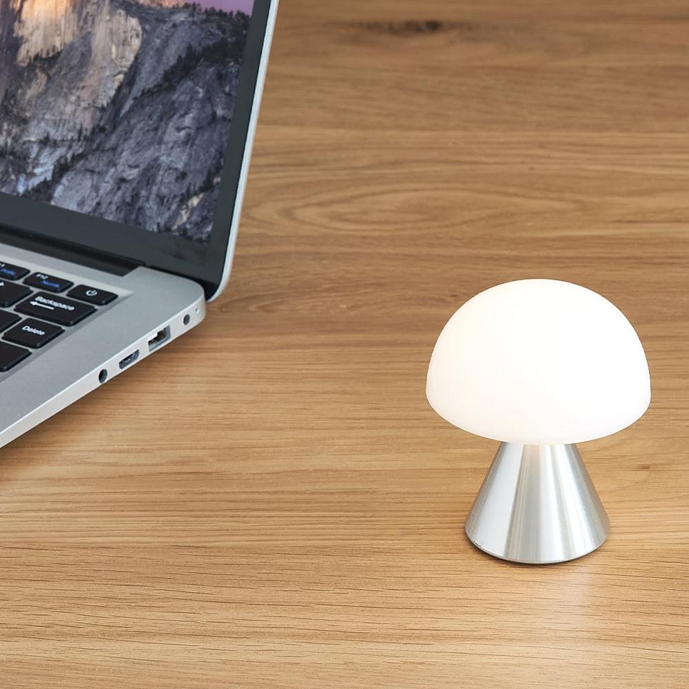 Mini LED lamp with glowing white dome shade and polished aluminum base