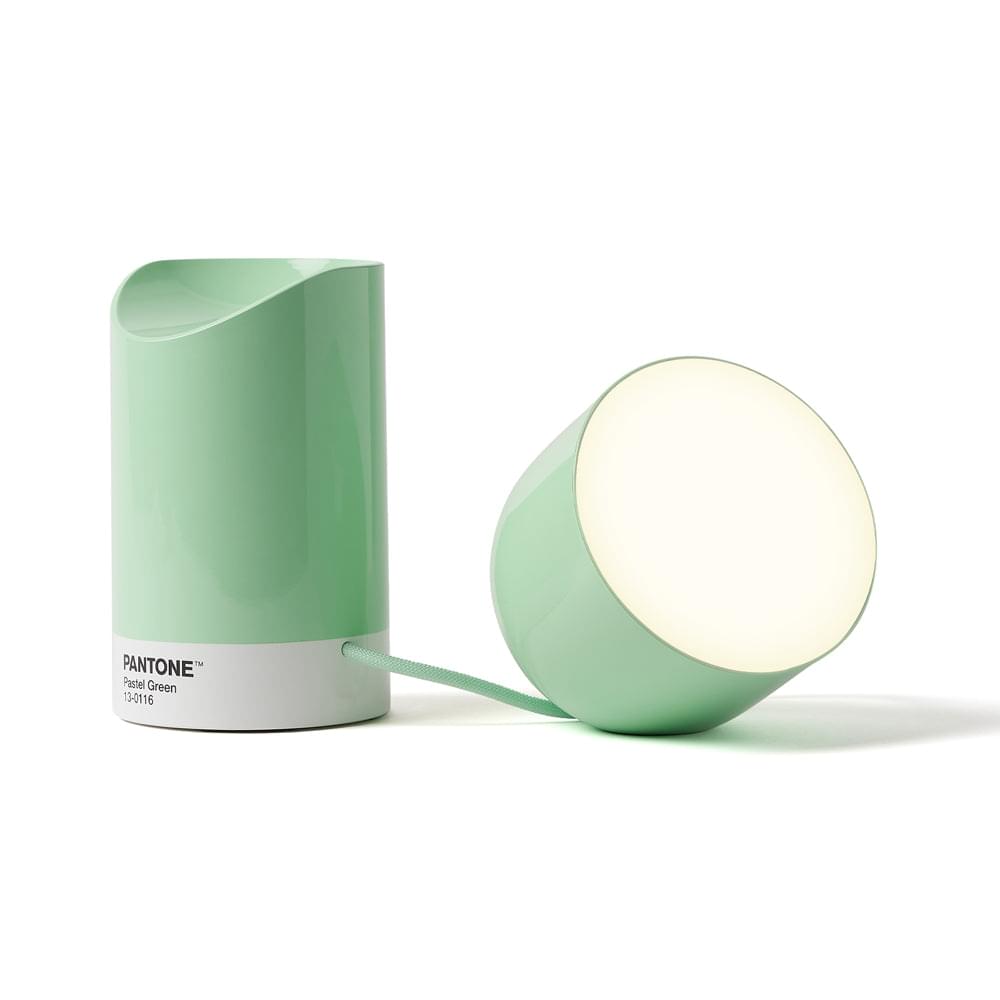 Pastel green portable LED lamp with glowing round head, side view and flexible cord