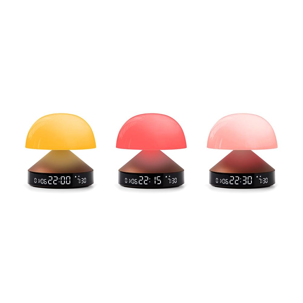 Set of three sunrise alarm clocks with yellow, red, and pink domes on black bases