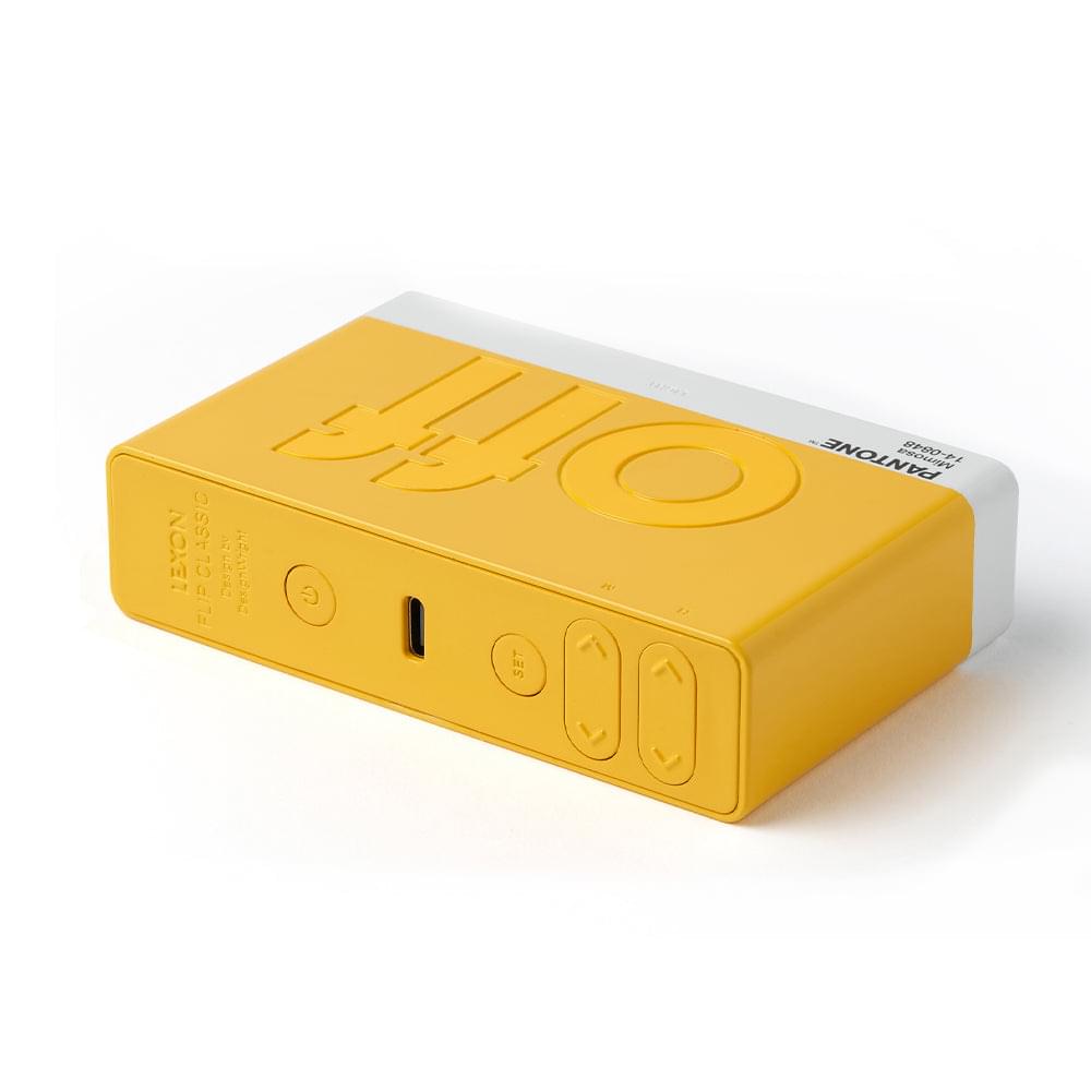 Yellow reversible flip alarm clock rear/side view with buttons and ports