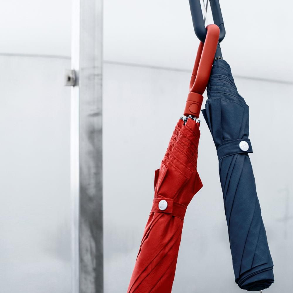 Lexon mini hook umbrella in red, closed with loop-and-hook handle