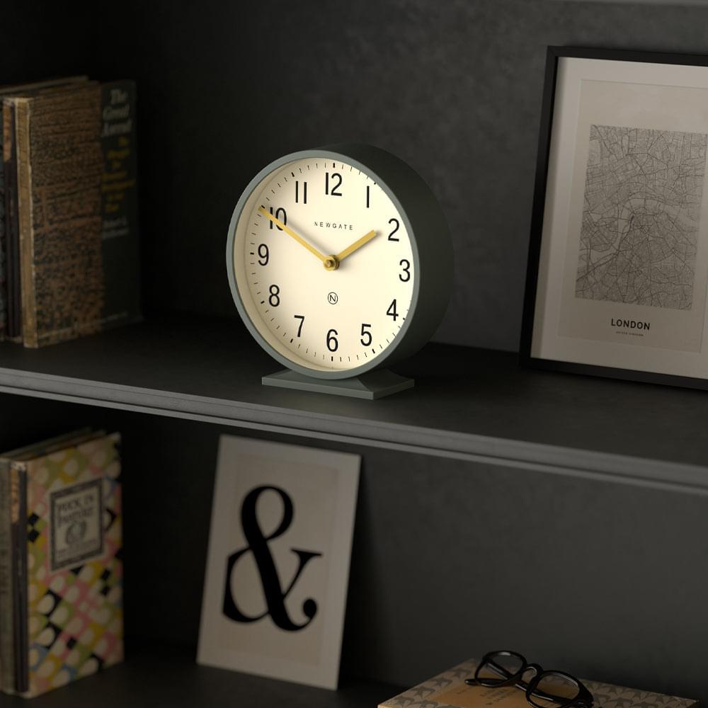 Asparagus green mantel clock with white dial, gold hands, and standing base