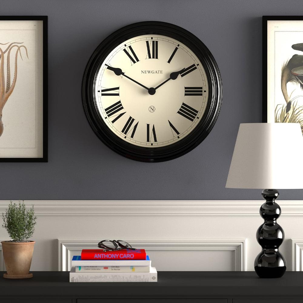 Black Newgate wall clock with cream dial, Roman numerals, and black hands
