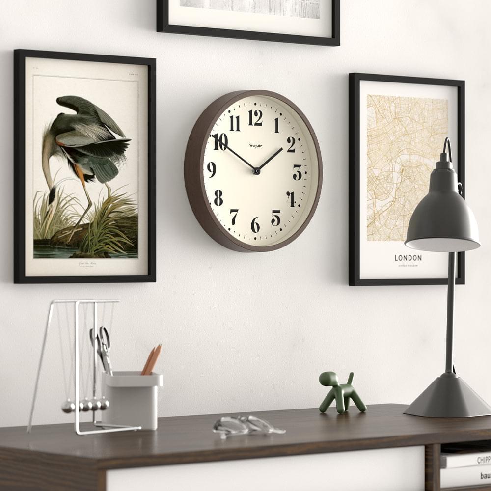 Round wall clock with dark wood frame and cream dial, black hour and minute hands