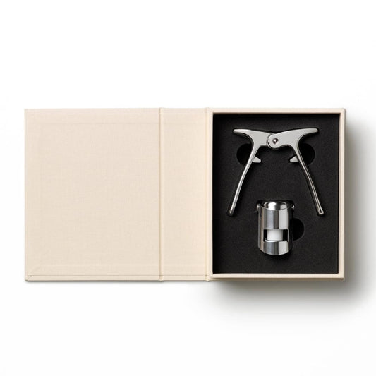 Champagne tools set in open beige box with black tray and metal cork opener