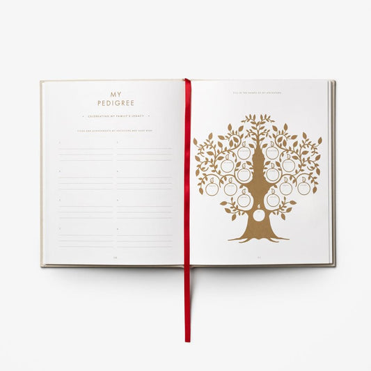 Open dog journal showing lined writing page and tree graphic on right with gold-brown ink.