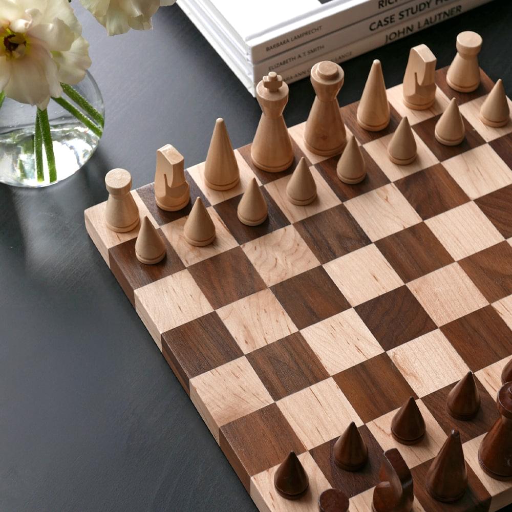 Wooden chessboard with square pattern and upright wooden chess pieces