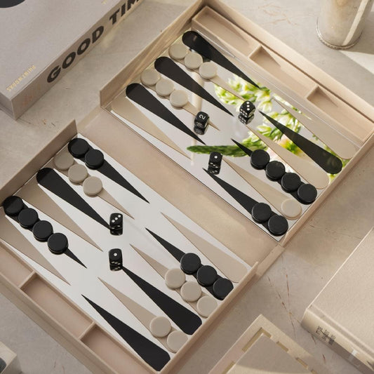 Backgammon game set in open tray with black and light checkers and dice