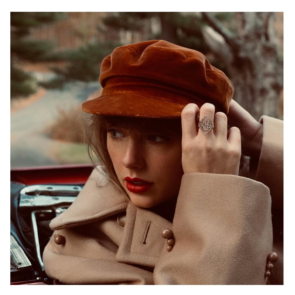Red vinyl album cover with portrait of woman in brown hat and red lipstick