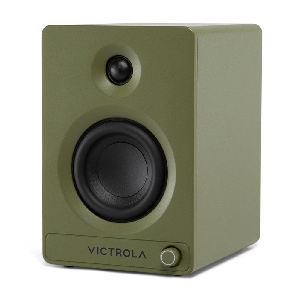 Green bookshelf speaker front view with black woofer, tweeter, and volume control dial
