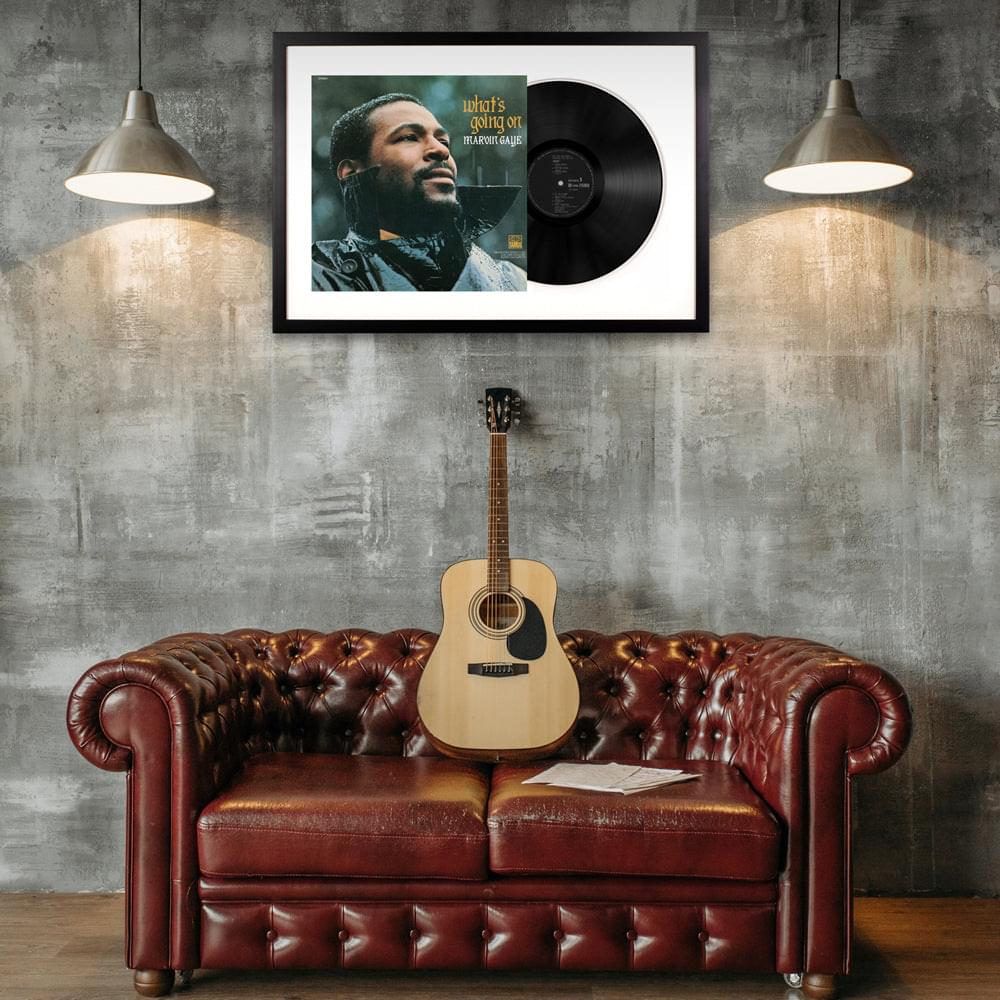 Framed vinyl album art with bearded portrait, black record, printed titles