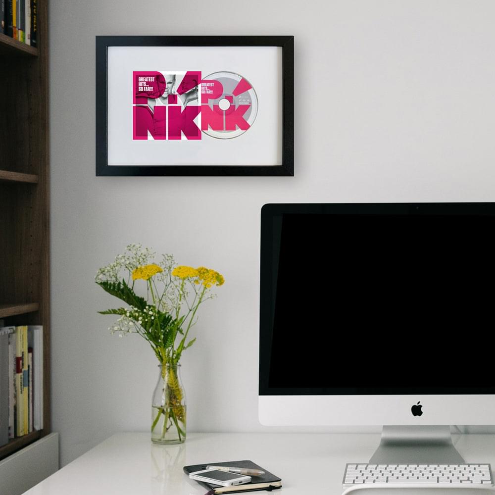 Framed CD album artwork in a gray frame with pink graphic design and disc