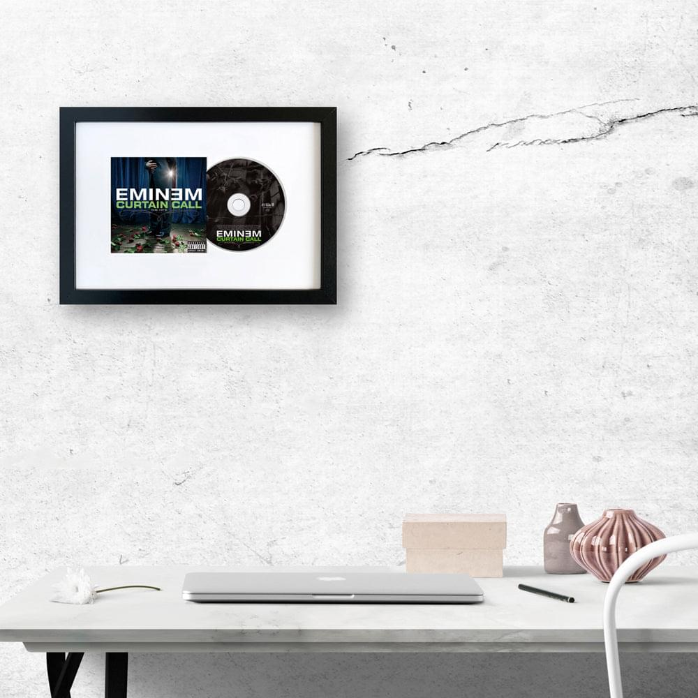 Framed CD album art with dark cover image and disc in a black frame