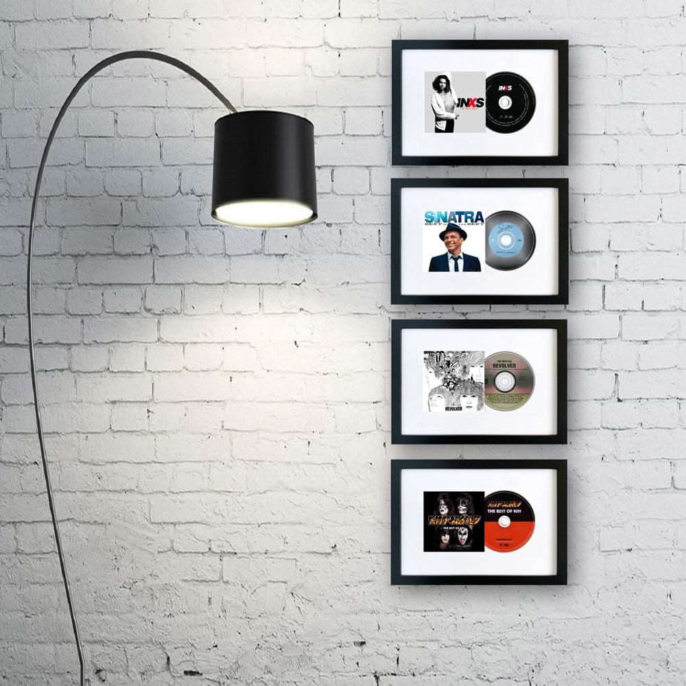 Framed Elvis album art CD prints in black frames on brick wall