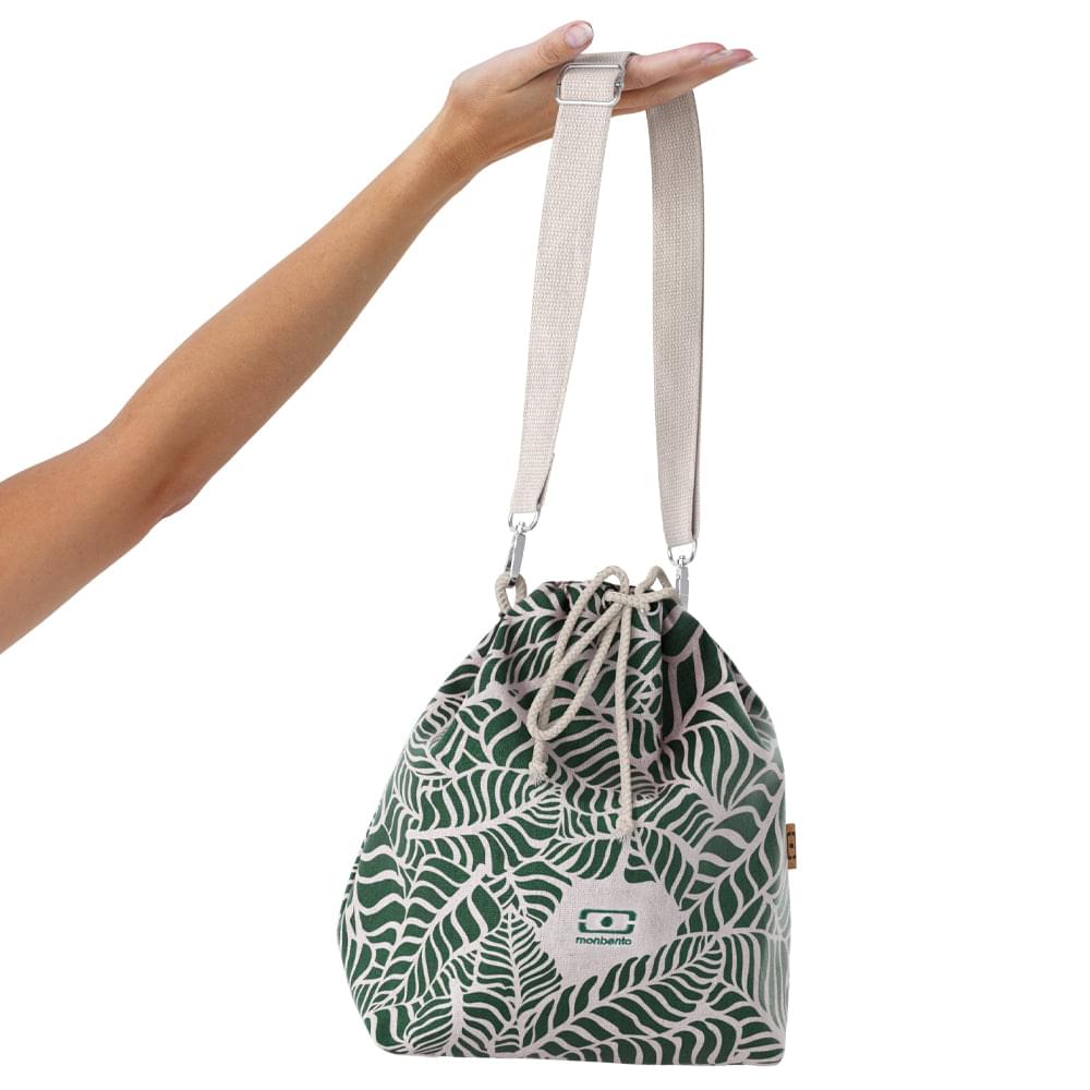 Leaf-print insulated lunch bag worn by hand, gray shoulder strap and monbento logo