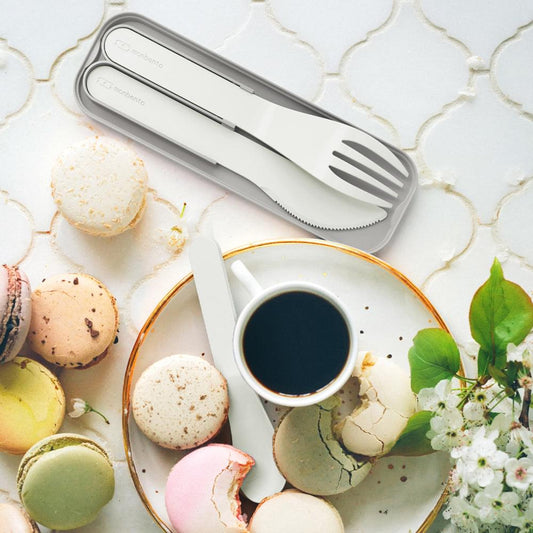 Pocket cutlery set with fork, knife, and spoon resting in gray carrying case