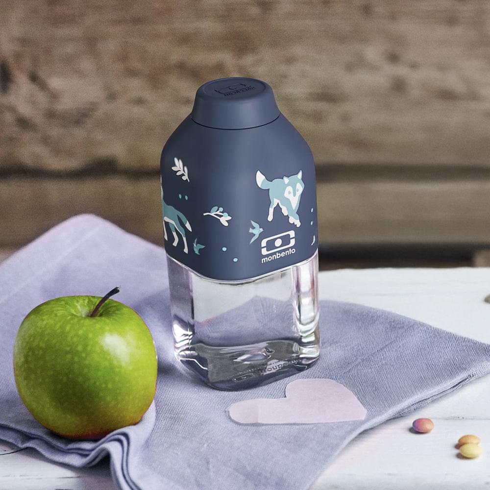 Reusable water bottle with navy wolf graphic and clear body, standing on cloth