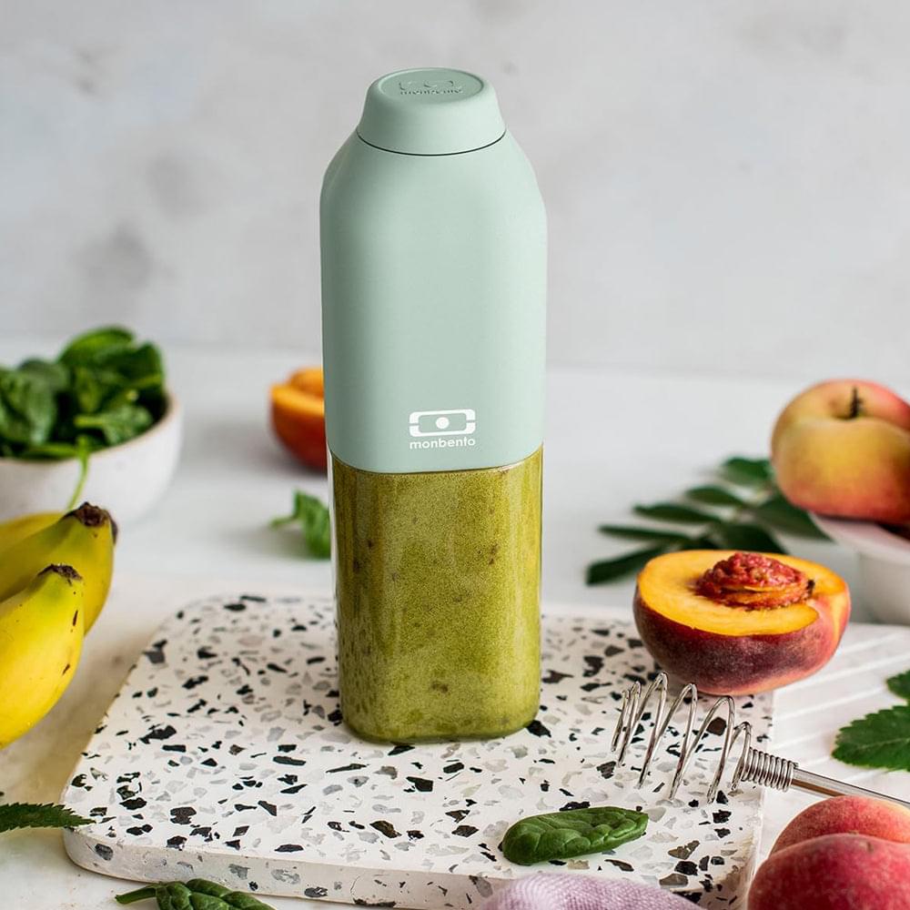 Green reusable water bottle standing upright with cap closed