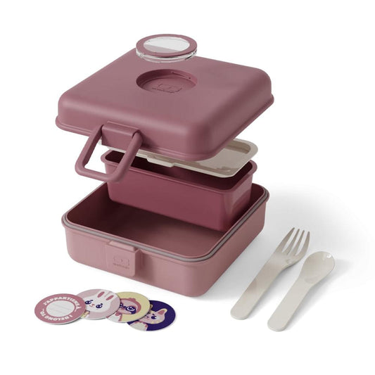 Pink lunch box open with two compartments, round cup lid, plus fork and spoon.