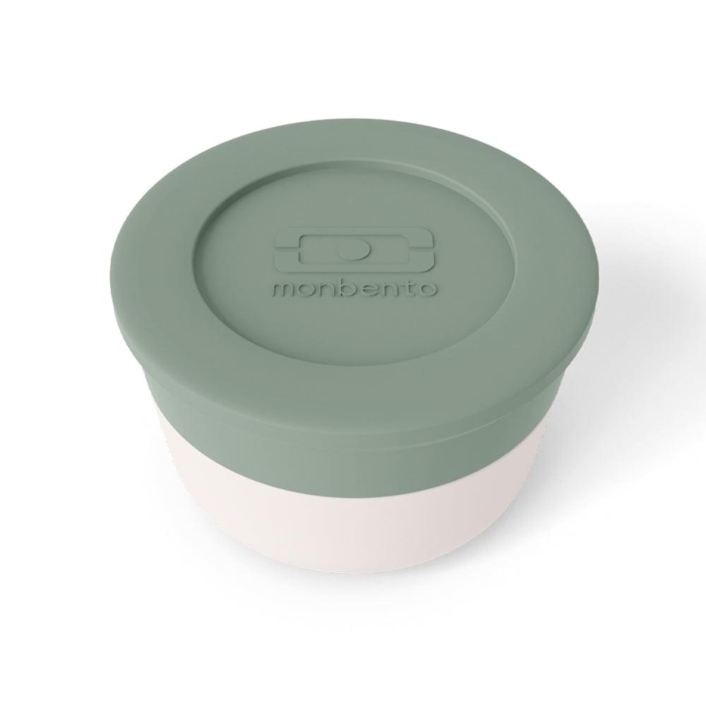 Monbento sauce cup lid close-up with embossed monbento logo, green
