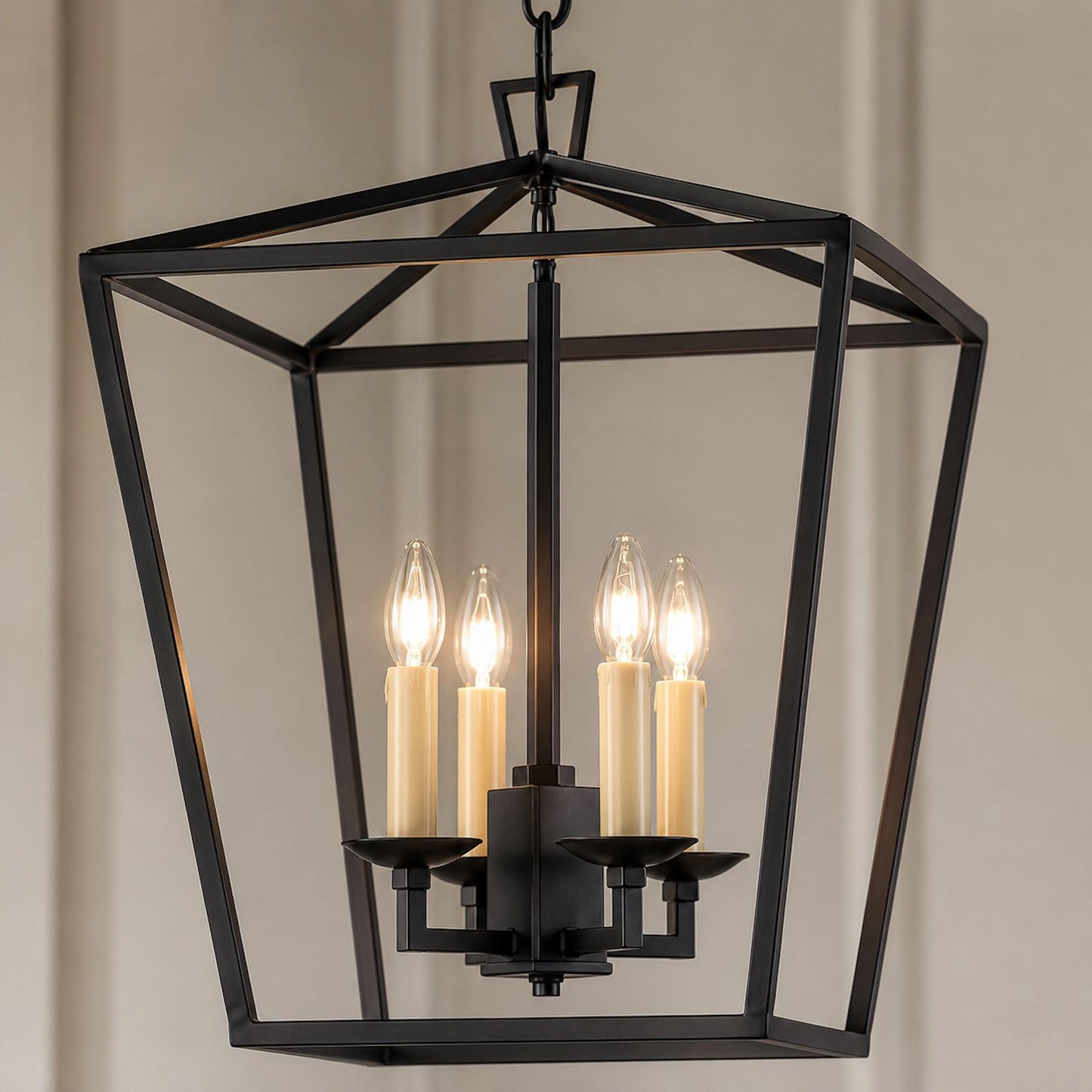Geometric matt black pendant lantern with four illuminated candle-style bulbs
