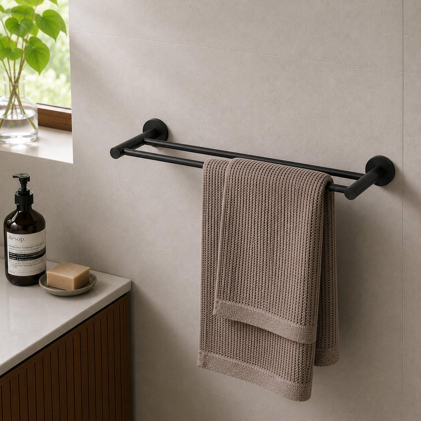 Matt black double towel rail with towel hanging from two horizontal bars and round end caps