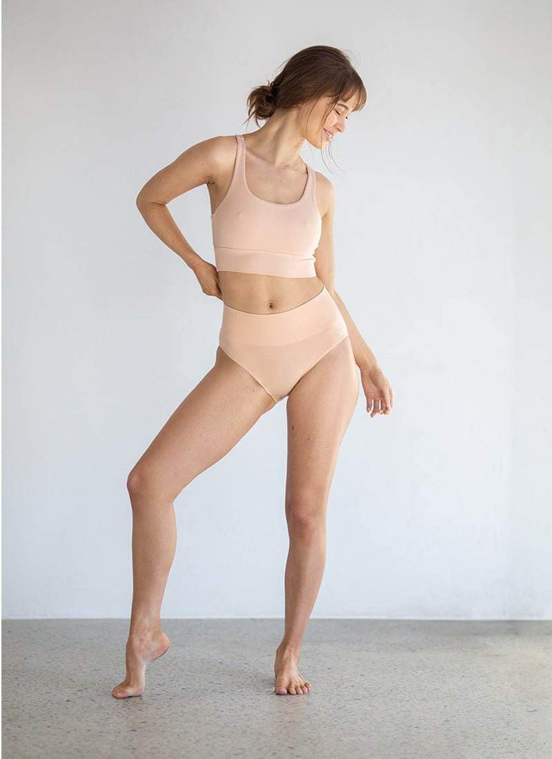 Beige bone briefs with smooth waistband, model standing full view
