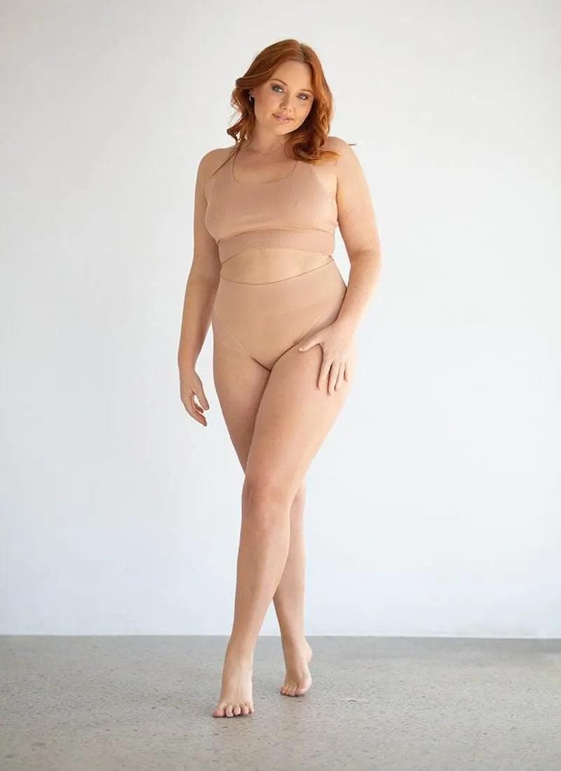 Beige high-rise lingerie briefs on model, full-body view
