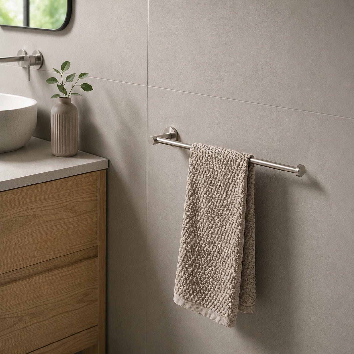 Brushed nickel hand towel holder with bar holding two folded hand towels