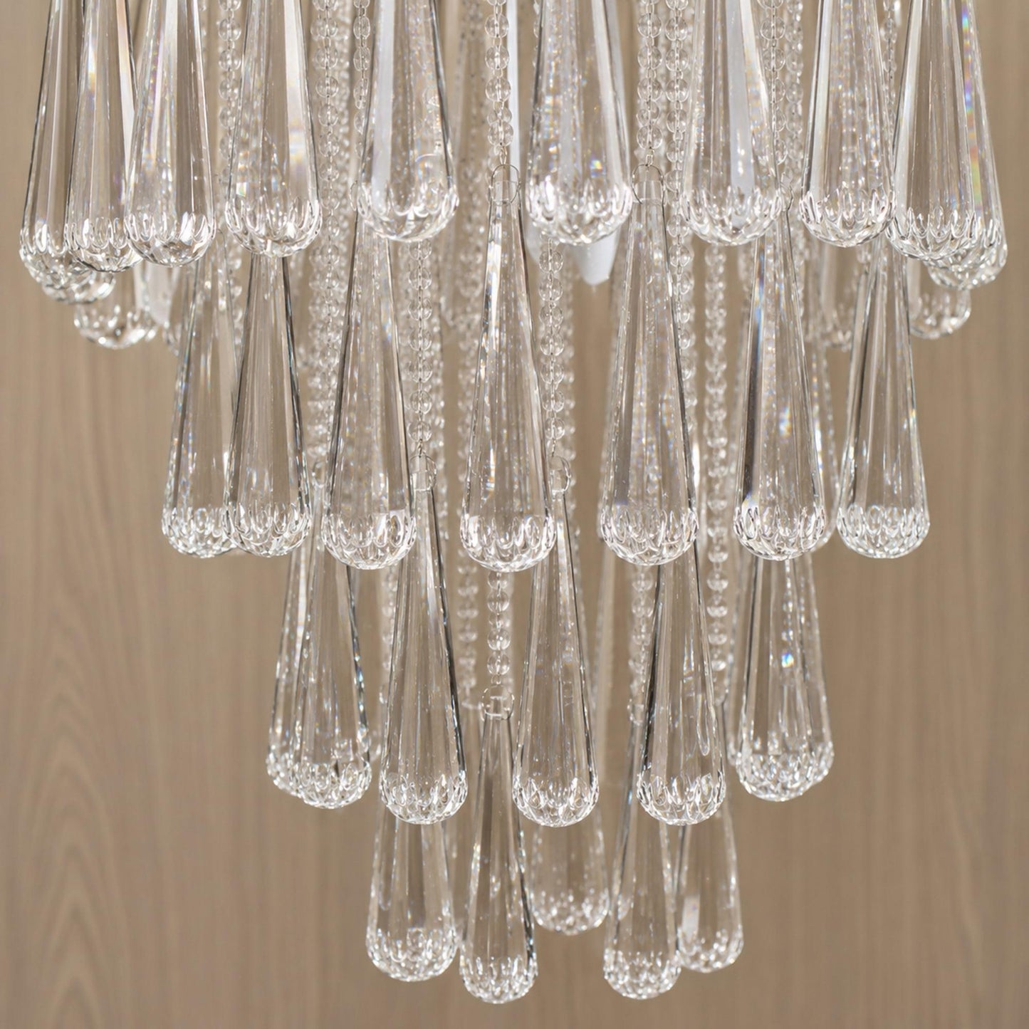 Close-up of clear crystal chandelier strands with faceted teardrop pendants