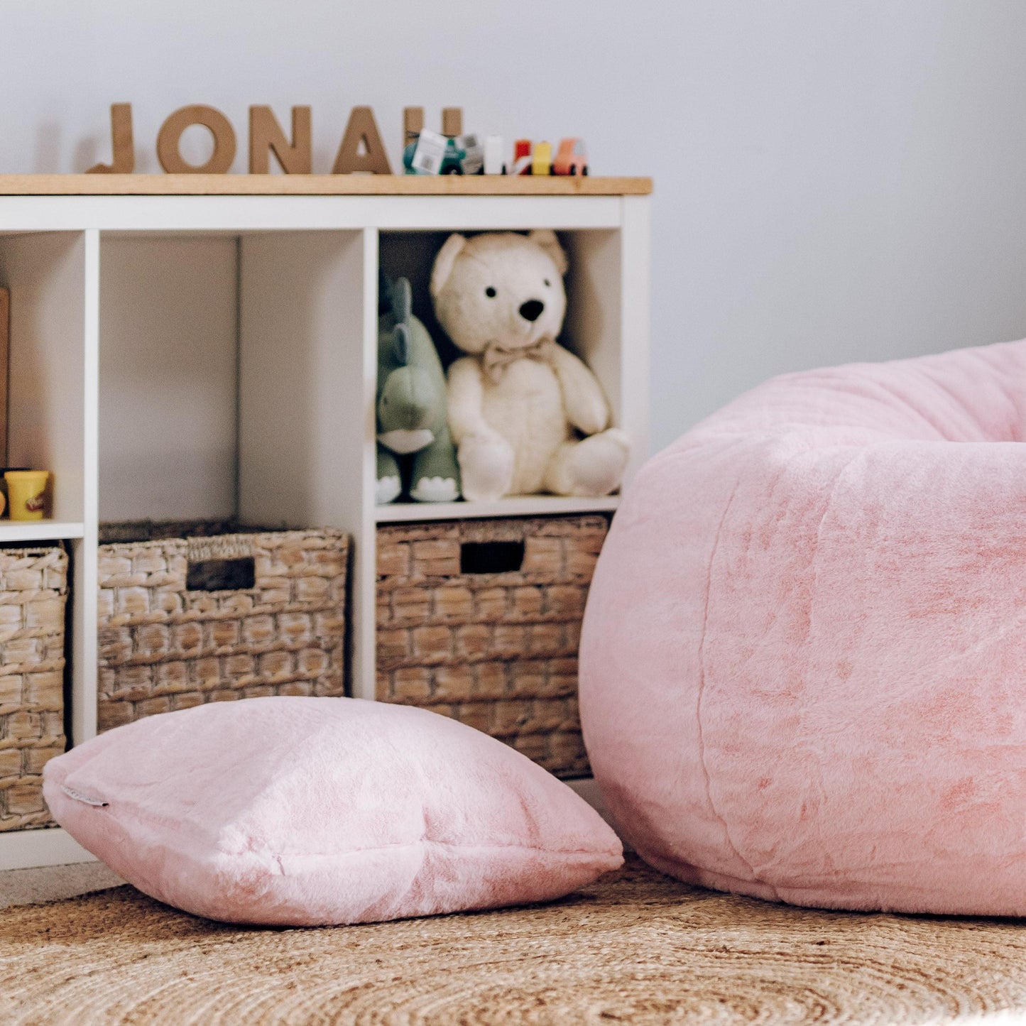 Soft pink plush fur cushion cover with insert, small square pillow beside large cushion