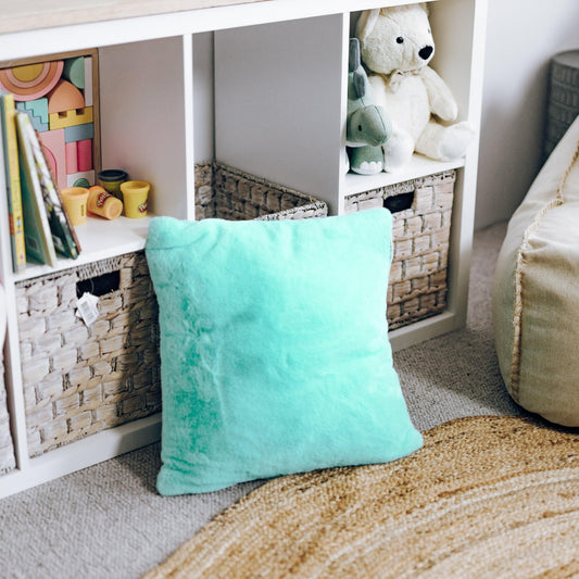 Turquoise plush fur square cushion pillow with cloud-like texture.