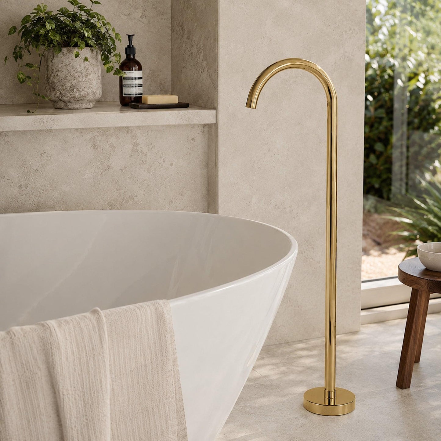 Freestanding bath spout with tall polished gold curved spout and round base