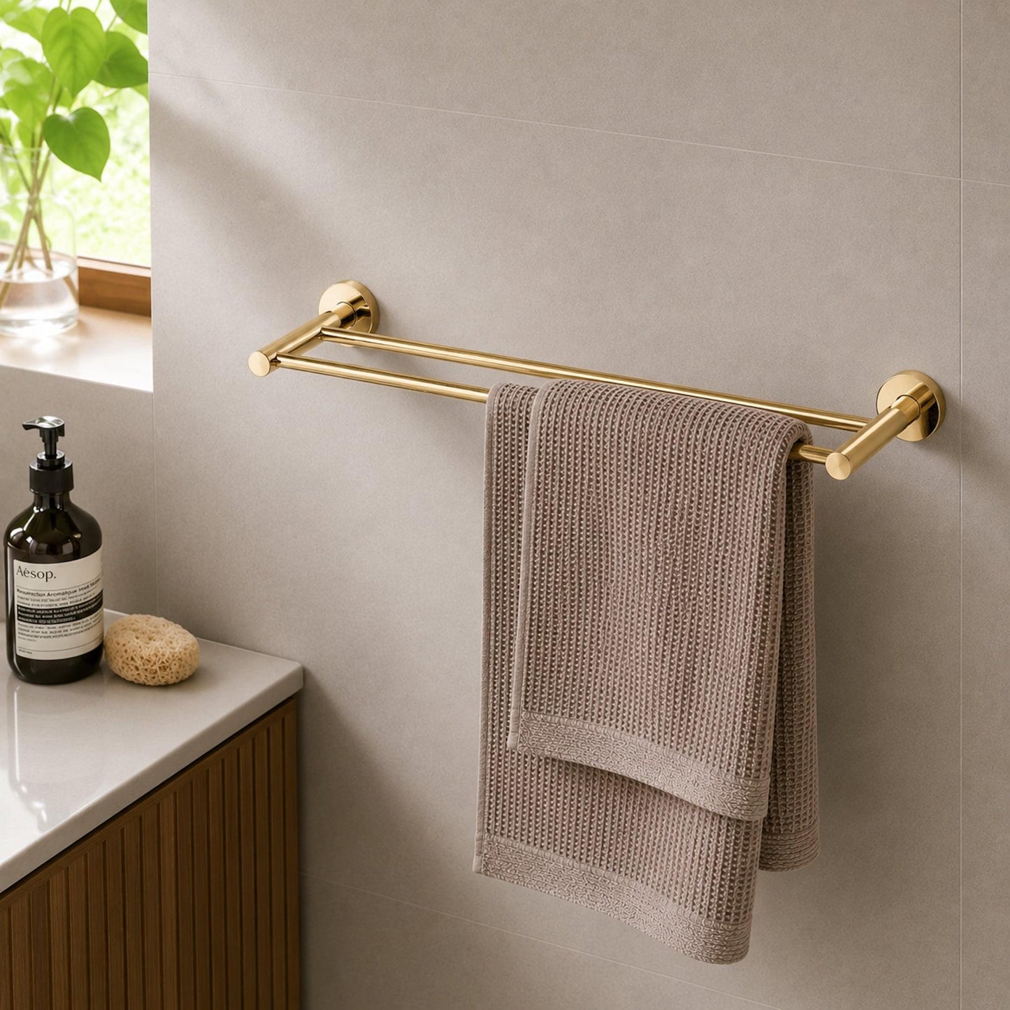 Wall-mounted polished gold double rail with beige towel hanging