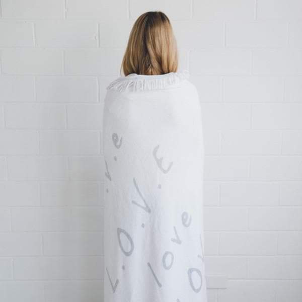 White round towel with gray love word print, shown from the back