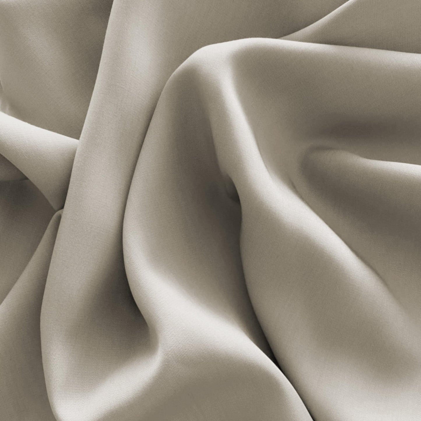 Latte-beige silky bamboo fabric close-up with soft drape and sheen
