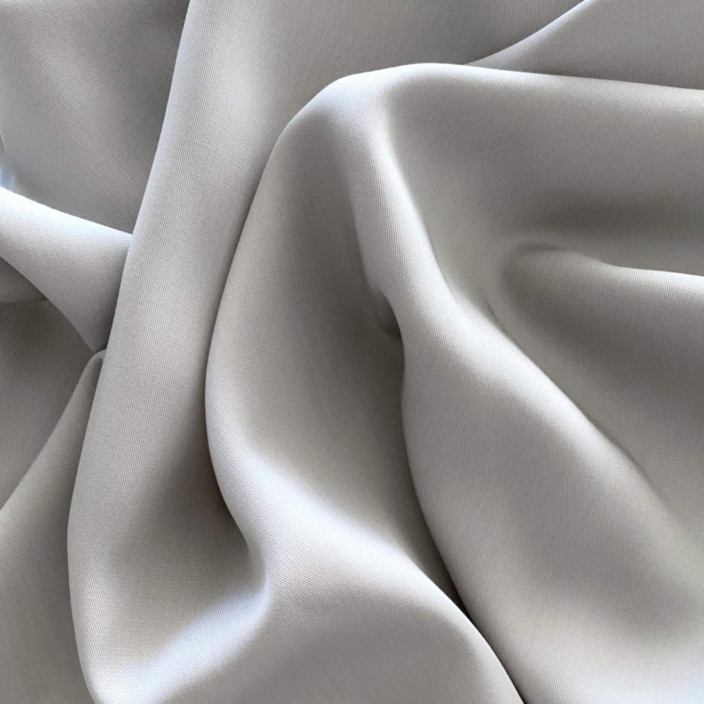 Silver quilt cover fabric close-up with soft silky sheen and smooth weave