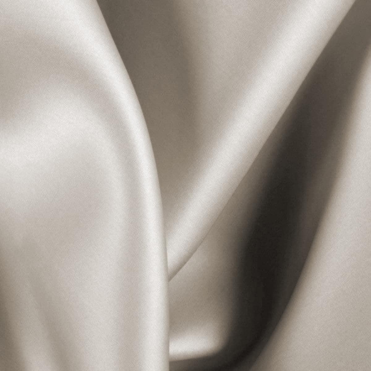 Latte bamboo sheet fabric close-up, silky sheen and fine weave texture